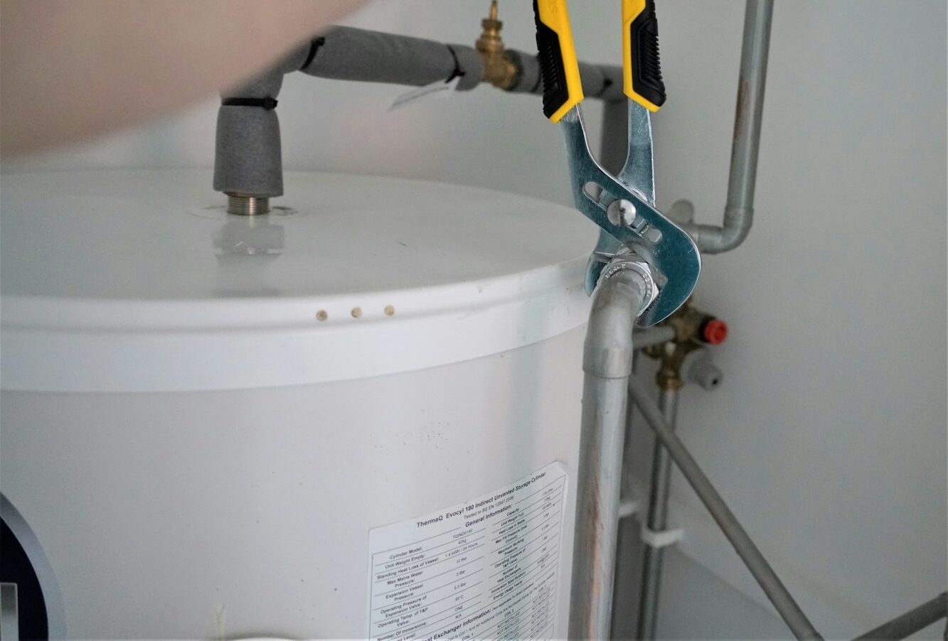 person holding yellow and gray hand tool